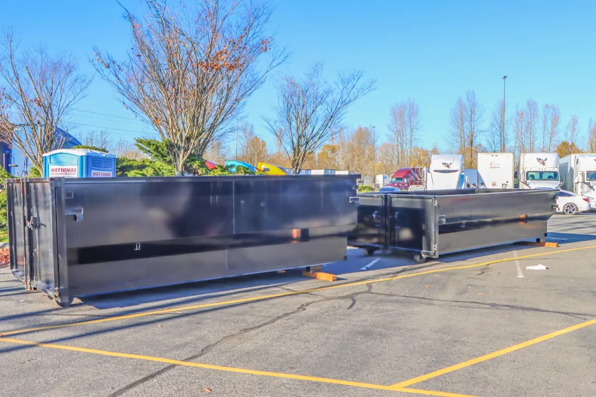 Professional dumpster rental service with roll-off container on residential driveway in Bellwood